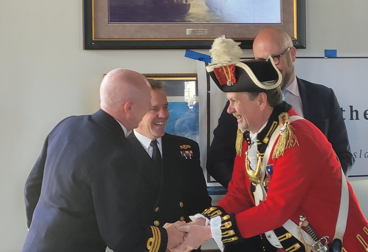 ACROSS THE POND PEERS: Col. Ron Barnes, Commander of the Pawtuxet Rangers, shook hands with representatives from the British government and Navy — from left to right, with British Naval Commander Steven White, of Her Majesty’s Royal Navy, Commander Simon Rogers, and Consul General for New England Dr. Peter Abbott OBE. (Beacon photo by Rory Schuler)
